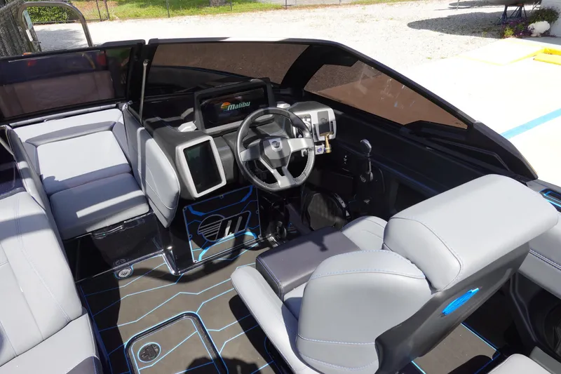 Slide: The Image of 2024 Malibu Wakesetter 23 MXZ interior with modern dashboard and seating. - 14