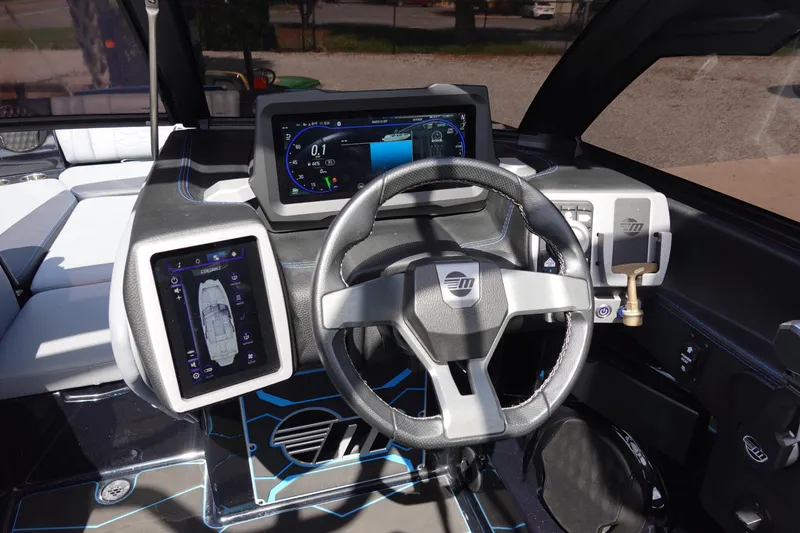 Slide: The Image of 2024 Malibu Wakesetter 23 MXZ dashboard with advanced controls and touchscreen displays. - 16