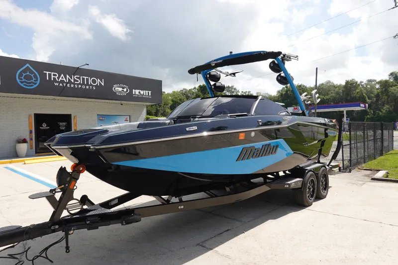 Slide: The Image of 2024 Malibu Wakesetter 23 MXZ boat on trailer at Transition Watersports dealership. - 2