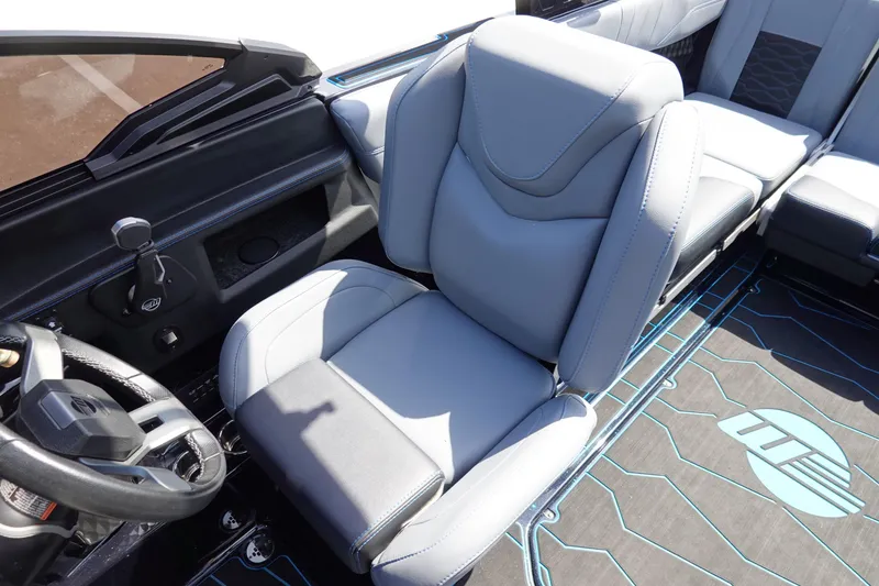 Slide: The Image of 2024 Malibu Wakesetter 23 MXZ interior with sleek, modern seating and steering wheel design. - 20