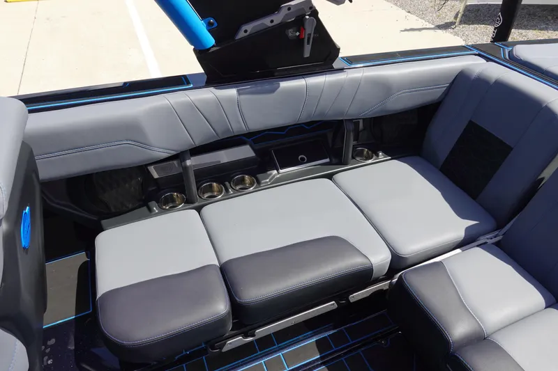 Slide: The Image of 2024 Malibu Wakesetter 23 MXZ interior seating with cup holders and sleek design. - 21