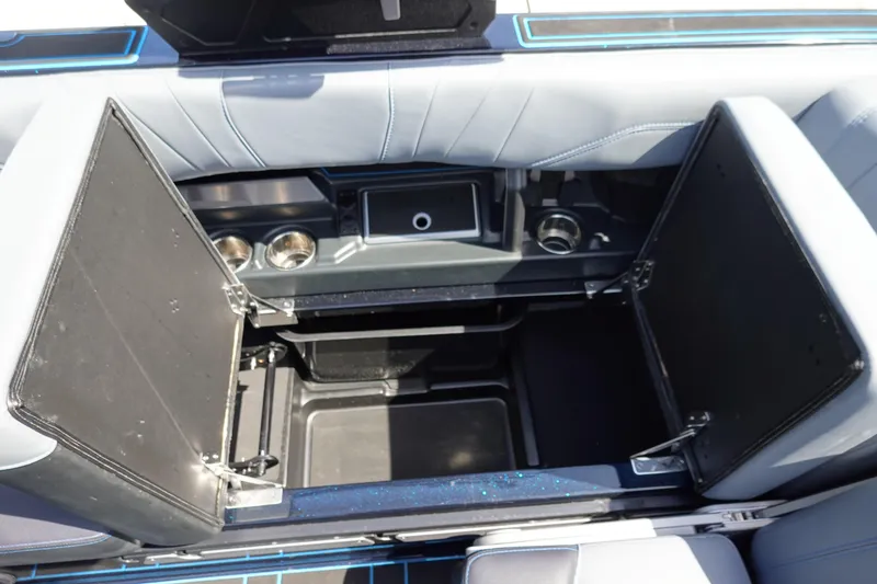 Slide: The Image of 2024 Malibu Wakesetter 23 MXZ boat storage compartment with cup holders and seating. - 22