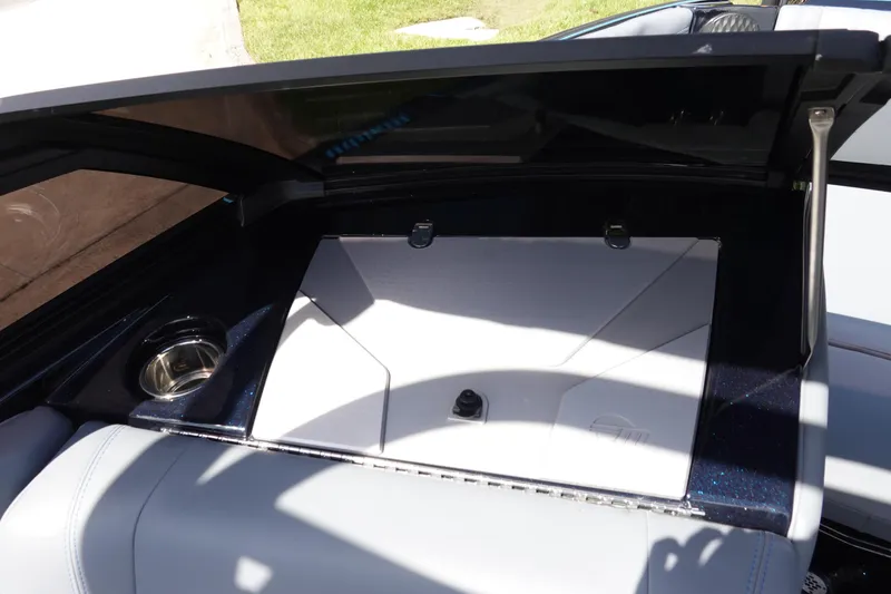 Slide: The Image of 2024 Malibu Wakesetter 23 MXZ interior storage compartment with cup holder. - 31