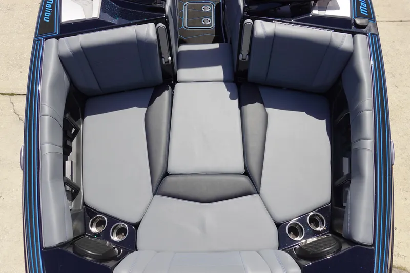 Slide: The Image of 2024 Malibu Wakesetter 23 MXZ boat interior with gray seating and cup holders. - 32