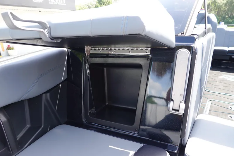 Slide: The Image of 2024 Malibu Wakesetter 23 MXZ boat storage compartment with open lid and sleek interior design. - 33