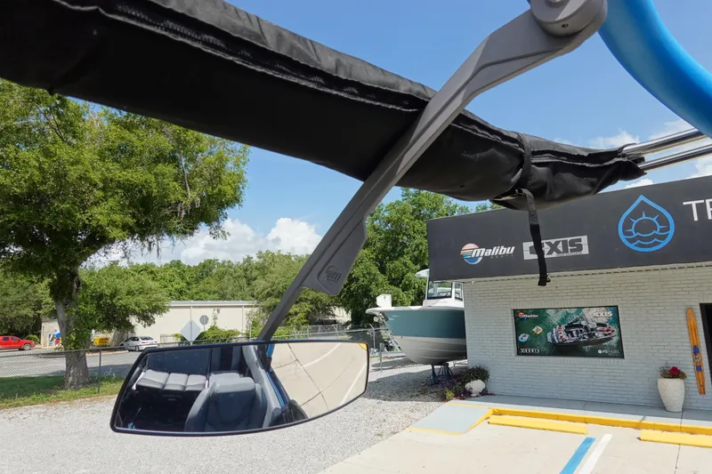Slide: The Image of 2024 Malibu Wakesetter 23 MXZ boat mirror and dealership exterior. - 36