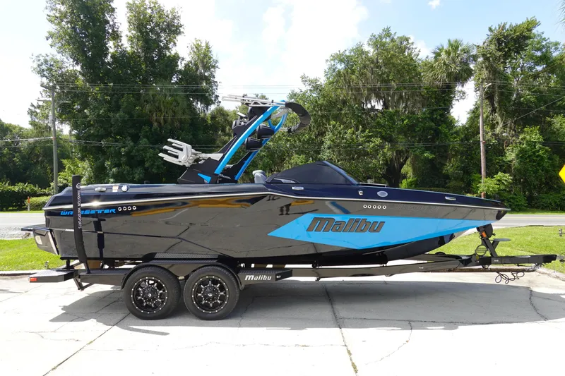 Slide: The Image of 2024 Malibu Wakesetter 23 MXZ boat on trailer, parked outdoors. - 4