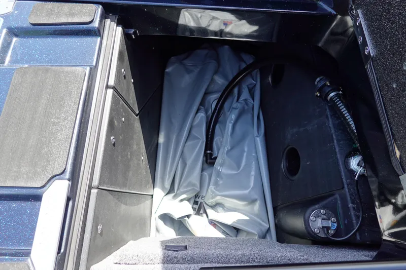Slide: The Image of 2024 Malibu Wakesetter 23 MXZ storage compartment with ballast bag and hose. - 40