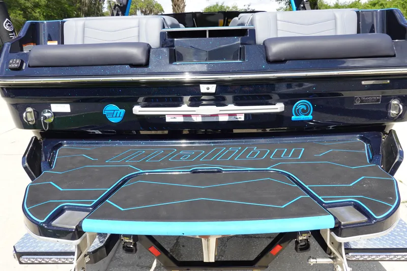 Slide: The Image of 2024 Malibu Wakesetter 23 MXZ boat rear view with branded swim platform. - 5