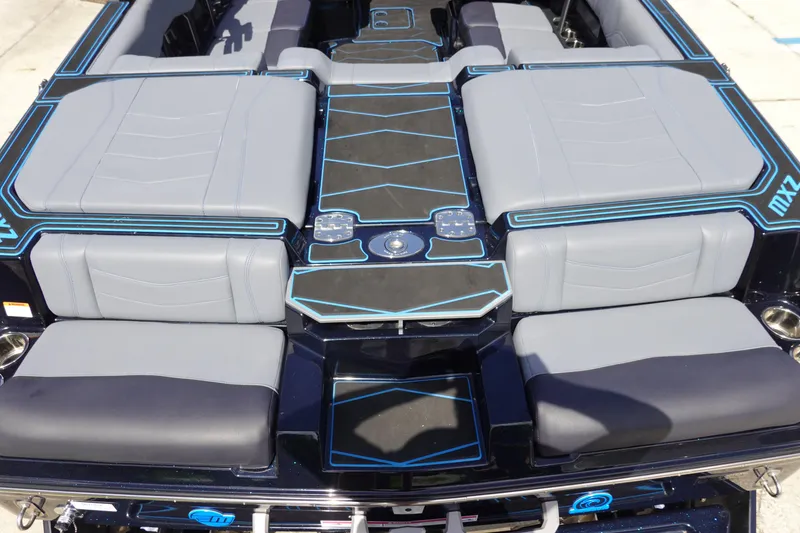 Slide: The Image of 2024 Malibu Wakesetter 23 MXZ boat interior with sleek gray and blue seating design. - 8