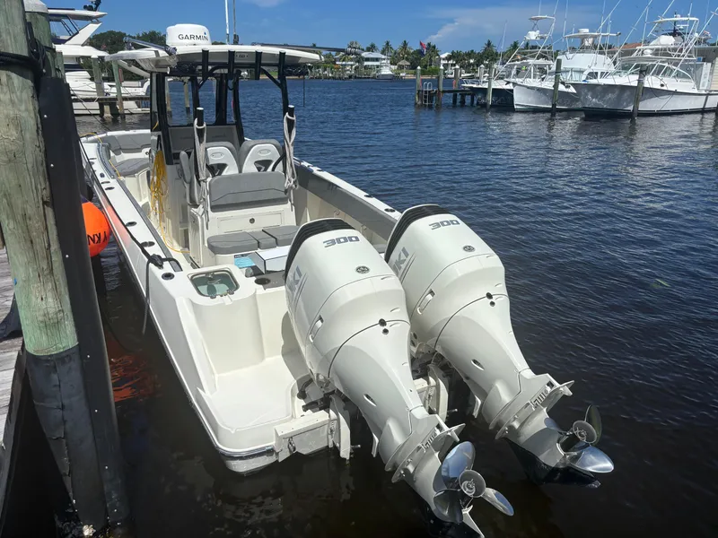 Slide: The Image of 2023 Stingray 273 CC boat with twin 300 horsepower engines docked at marina. - 3