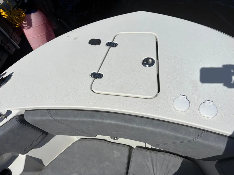 Slide: The Image of 2023 Stingray 273 CC boat deck with storage hatch and seating area. - 5