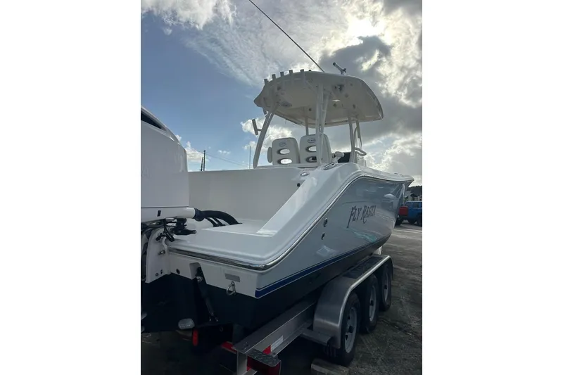 Slide: The Image of 2017 Cobia 296 Center Console boat on trailer under cloudy sky. - 20