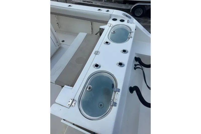 Slide: The Image of 2017 Cobia 296 Center Console boat with livewell and seating area. - 23