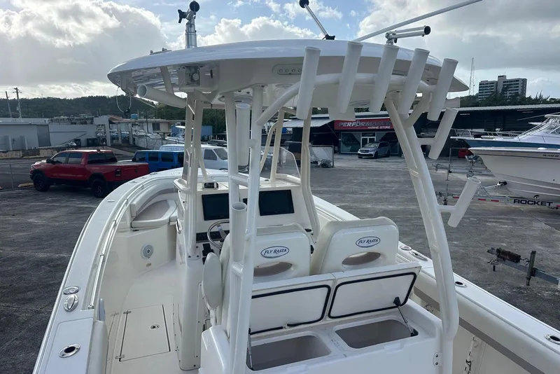 Slide: The Image of 2017 Cobia 296 Center Console boat with dual helm seats and rod holders. - 26