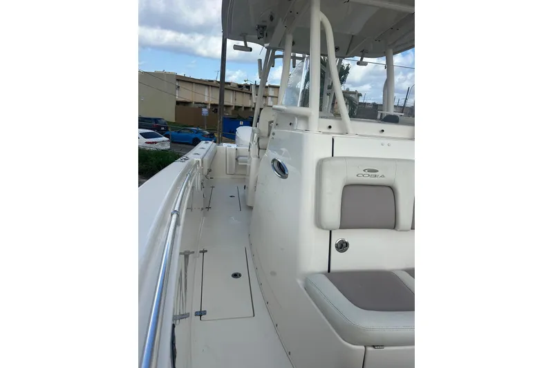 Slide: The Image of 2017 Cobia 296 Center Console boat with sleek white deck and seating. - 28