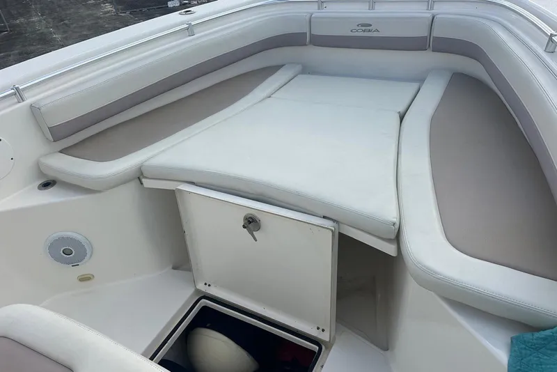 Slide: The Image of 2017 Cobia 296 Center Console boat interior with cushioned seating and storage compartment. - 30
