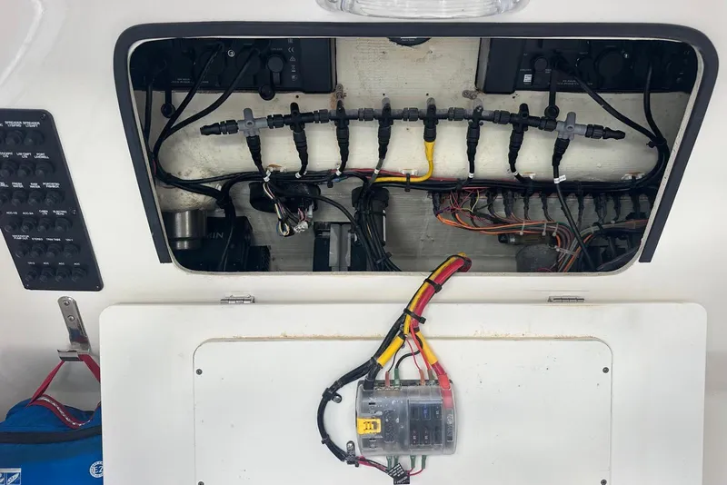 Slide: The Image of Electrical wiring panel inside a 2017 Cobia 296 Center Console boat. - 44