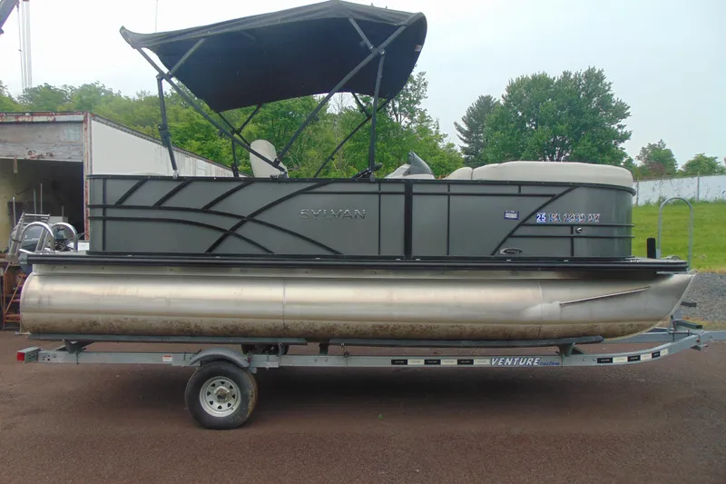 The Image of 2020 Sylvan Mirage 8520 Cruise pontoon boat on trailer, with canopy, parked outdoors. - 1