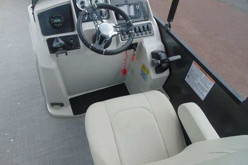 Slide: The Image of 2020 Sylvan Mirage 8520 Cruise boat helm with steering wheel and control panel. - 11