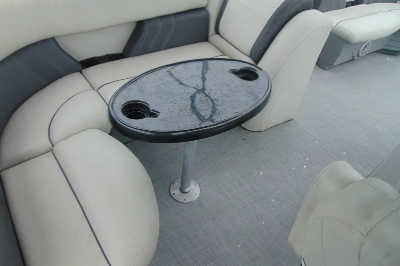 Slide: The Image of 2020 Sylvan Mirage 8520 Cruise interior with wet table and cushioned seating. - 12