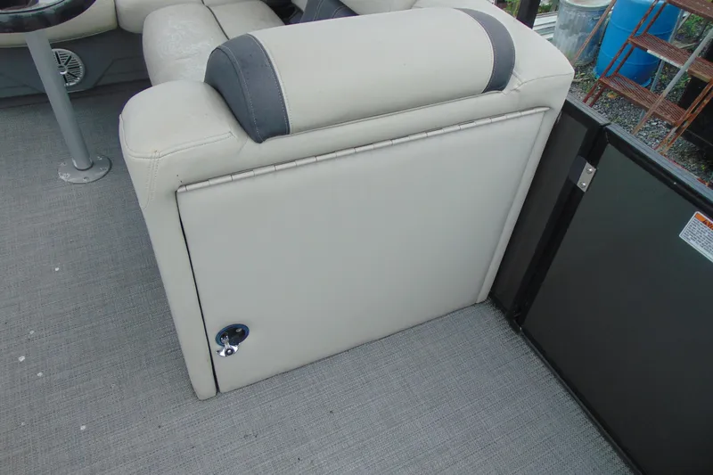 Slide: The Image of 2020 Sylvan Mirage 8520 Cruise boat interior with cushioned seating and storage compartment. - 15