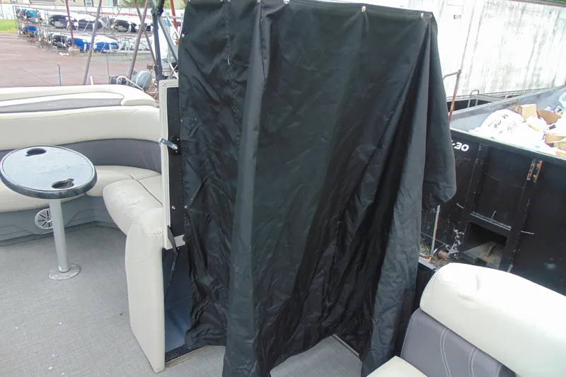 Slide: The Image of 2020 Sylvan Mirage 8520 Cruise interior with seating and table, covered area visible. - 16