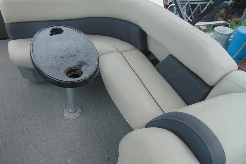 Slide: The Image of 2020 Sylvan Mirage 8520 Cruise boat interior with cushioned seating and a small table. - 9