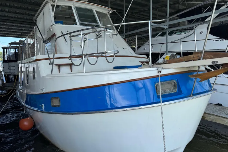 The Image of 1984 Kadey-Krogen 36 Manatee boat docked in a marina, featuring blue and white hull. - 0