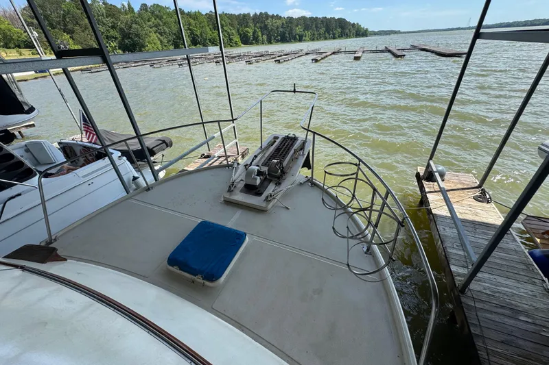 Slide: The Image of 1984 Kadey-Krogen 36 Manatee docked on a scenic lake with lush greenery. - 12