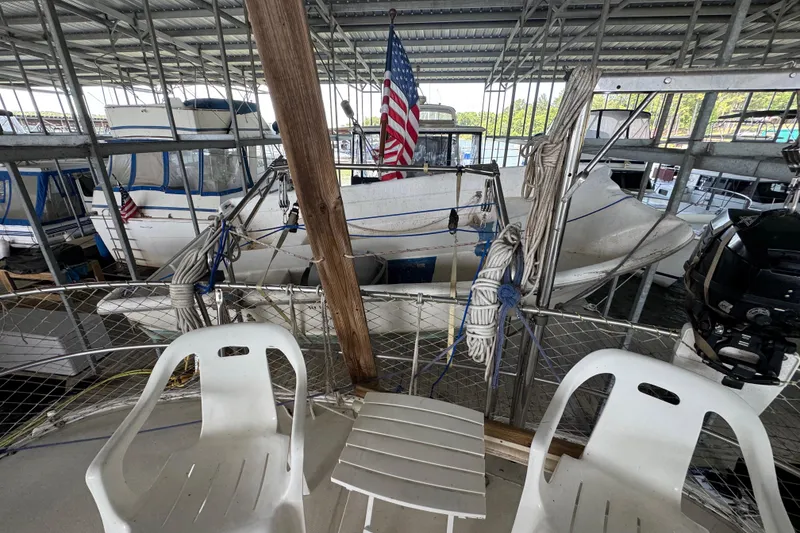 Slide: The Image of 1984 Kadey-Krogen 36 Manatee docked in a covered marina with American flag. - 17
