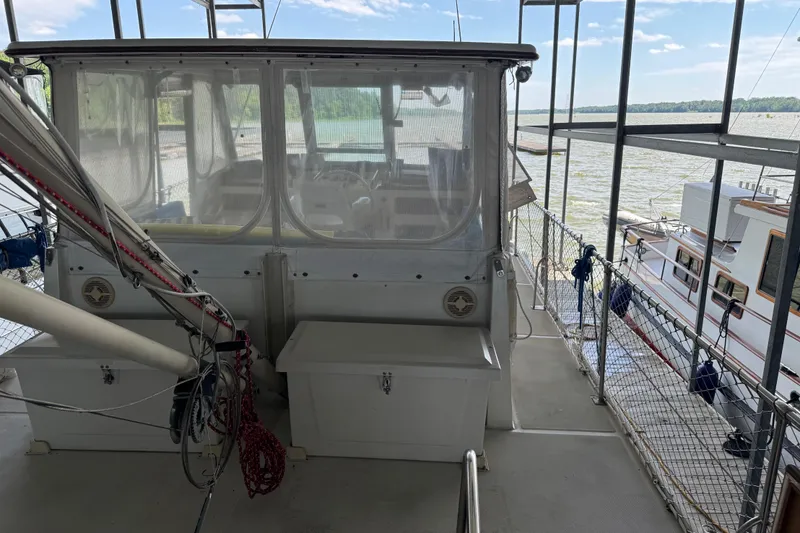 Slide: The Image of 1984 Kadey-Krogen 36 Manatee boat docked, featuring enclosed cockpit and scenic waterfront view. - 18