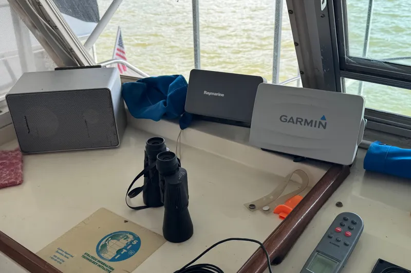 Slide: The Image of Navigation equipment on 1984 Kadey-Krogen 36 Manatee boat, featuring Garmin and Raymarine devices. - 22