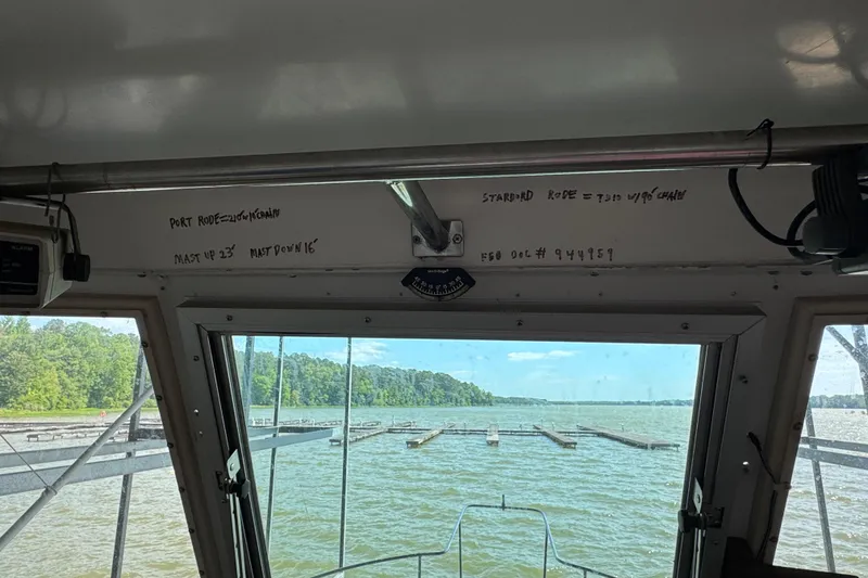 Slide: The Image of Interior view from a 1984 Kadey-Krogen 36 Manatee boat, overlooking a serene lake. - 26