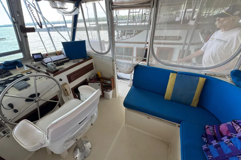 Slide: The Image of Interior of 1984 Kadey-Krogen 36 Manatee boat with steering wheel and blue seating. - 28