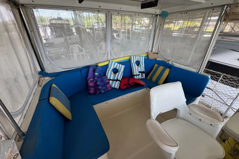 Slide: The Image of 1984 Kadey-Krogen 36 Manatee interior with blue seating and striped cushions. - 30