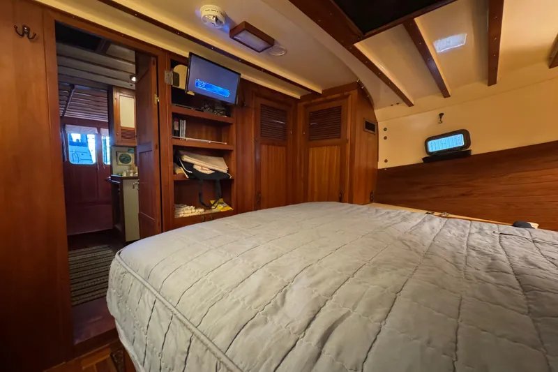 Slide: The Image of Cozy cabin interior of 1984 Kadey-Krogen 36 Manatee with wood paneling and bed. - 58