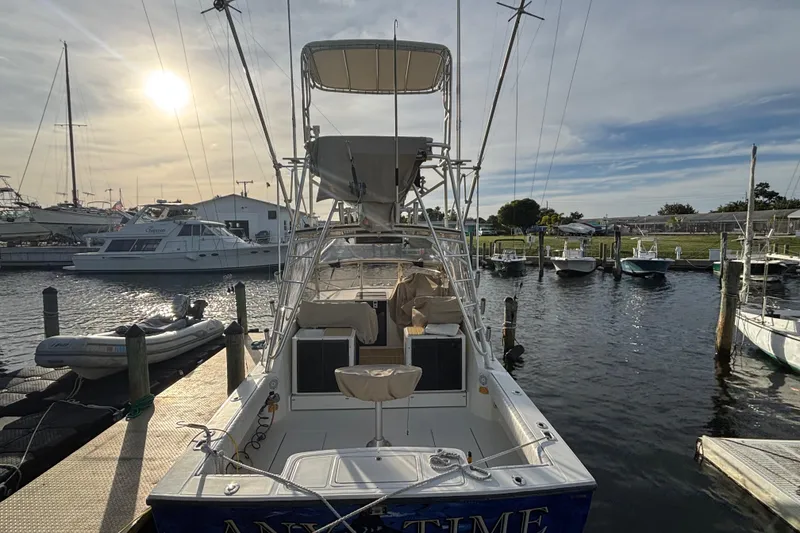Slide: The Image of 2003 Carolina Classic 28 boat docked at marina during sunset. - 6