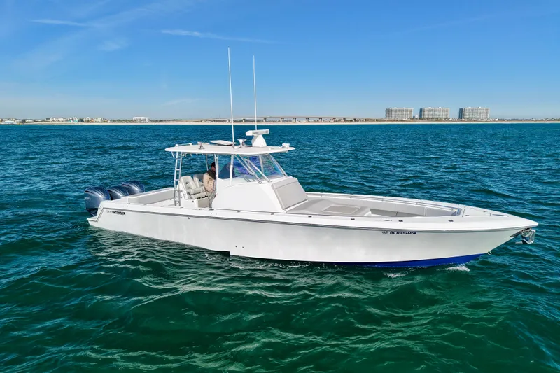 The Image of 2022 Contender 39 Fisharound boat cruising on open water under clear blue skies. - 1