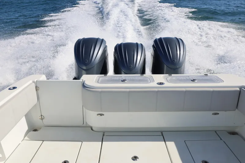 Slide: The Image of 2022 Contender 39 Fisharound boat with triple engines cruising on open water. - 11