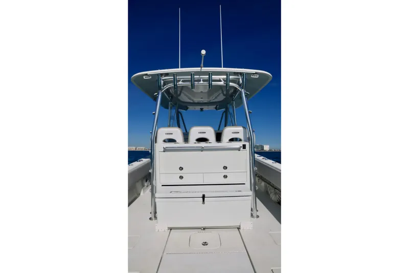 Slide: The Image of 2022 Contender 39 Fisharound boat, center console view, clear blue sky background. - 14