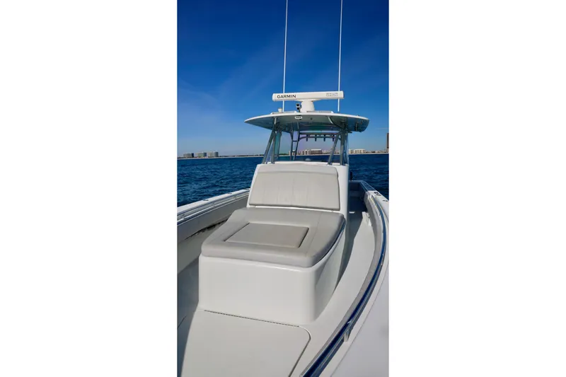 Slide: The Image of 2022 Contender 39 Fisharound boat on open water under clear blue sky. - 15