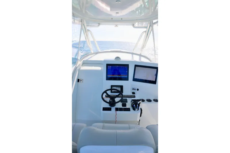 Slide: The Image of 2022 Contender 39 Fisharound helm with dual screens and steering wheel. - 16