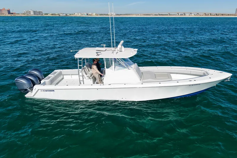 Slide: The Image of 2022 Contender 39 Fisharound boat cruising on open water. - 2