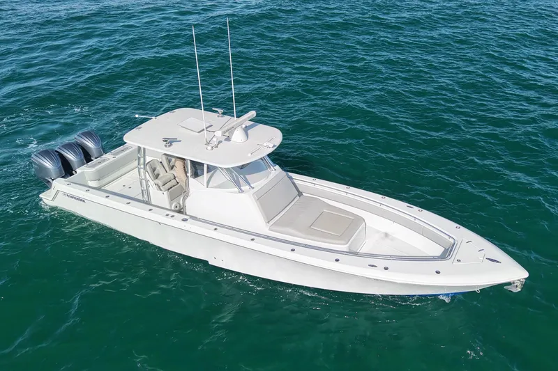 Slide: The Image of 2022 Contender 39 Fisharound boat cruising on open water, showcasing sleek design and twin engines. - 3