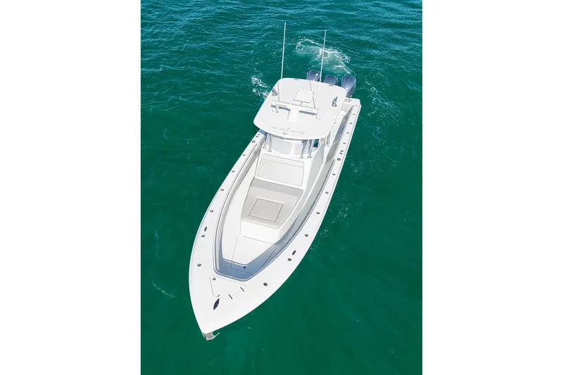 Slide: The Image of 2022 Contender 39 Fisharound boat cruising on clear blue water. - 5