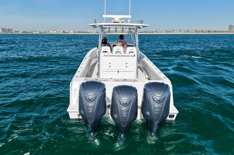 Slide: The Image of 2022 Contender 39 Fisharound boat with triple outboard engines on open water. - 6