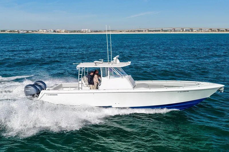 Slide: The Image of 2022 Contender 39 Fisharound cruising on open water with dual outboard engines. - 7