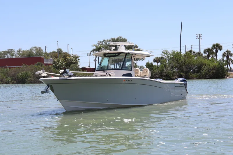 Slide: The Image of 2021 Grady-White Canyon 336 boat cruising on a sunny day in calm waters. - 10