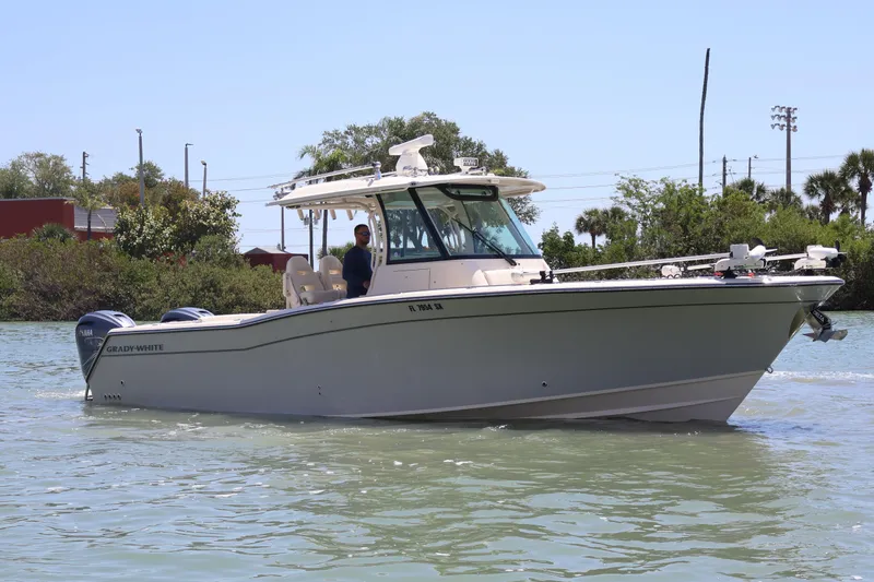 Slide: The Image of 2021 Grady-White Canyon 336 boat cruising on a sunny day in calm waters. - 12